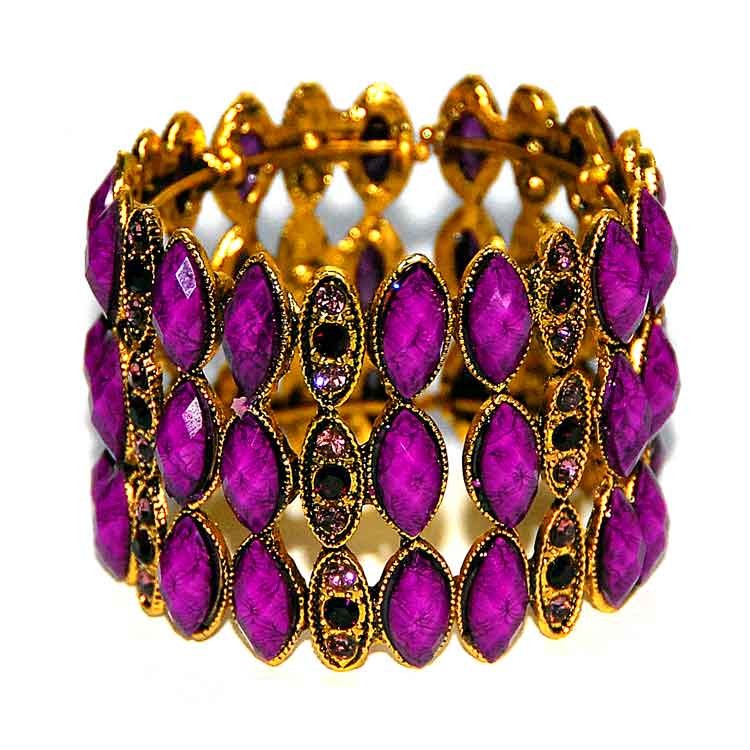 Браслет Royal Purple Браслет из металла под золото, в форме манжета, украшен яркими фиолетовыми стразами и кабошонами.